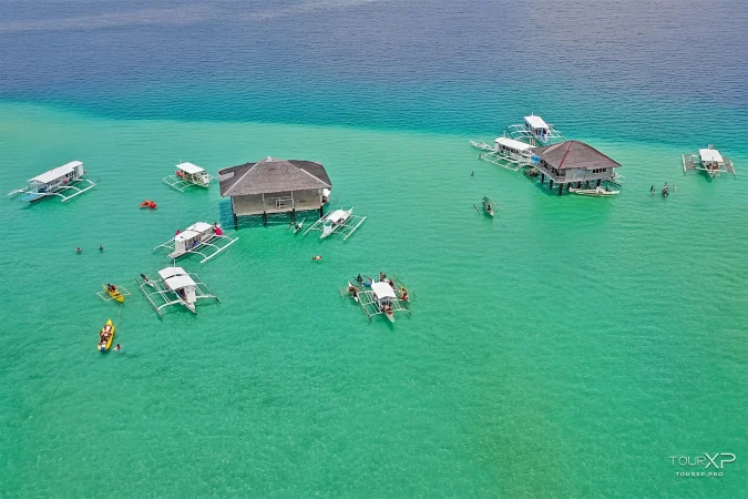 Floating cottages standing on Manjuyod White Sand Bar at low tide